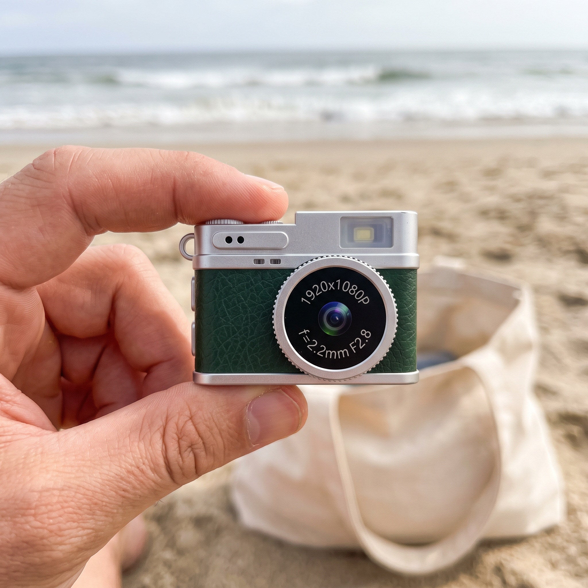 Green Little Snap mini camera at the beach