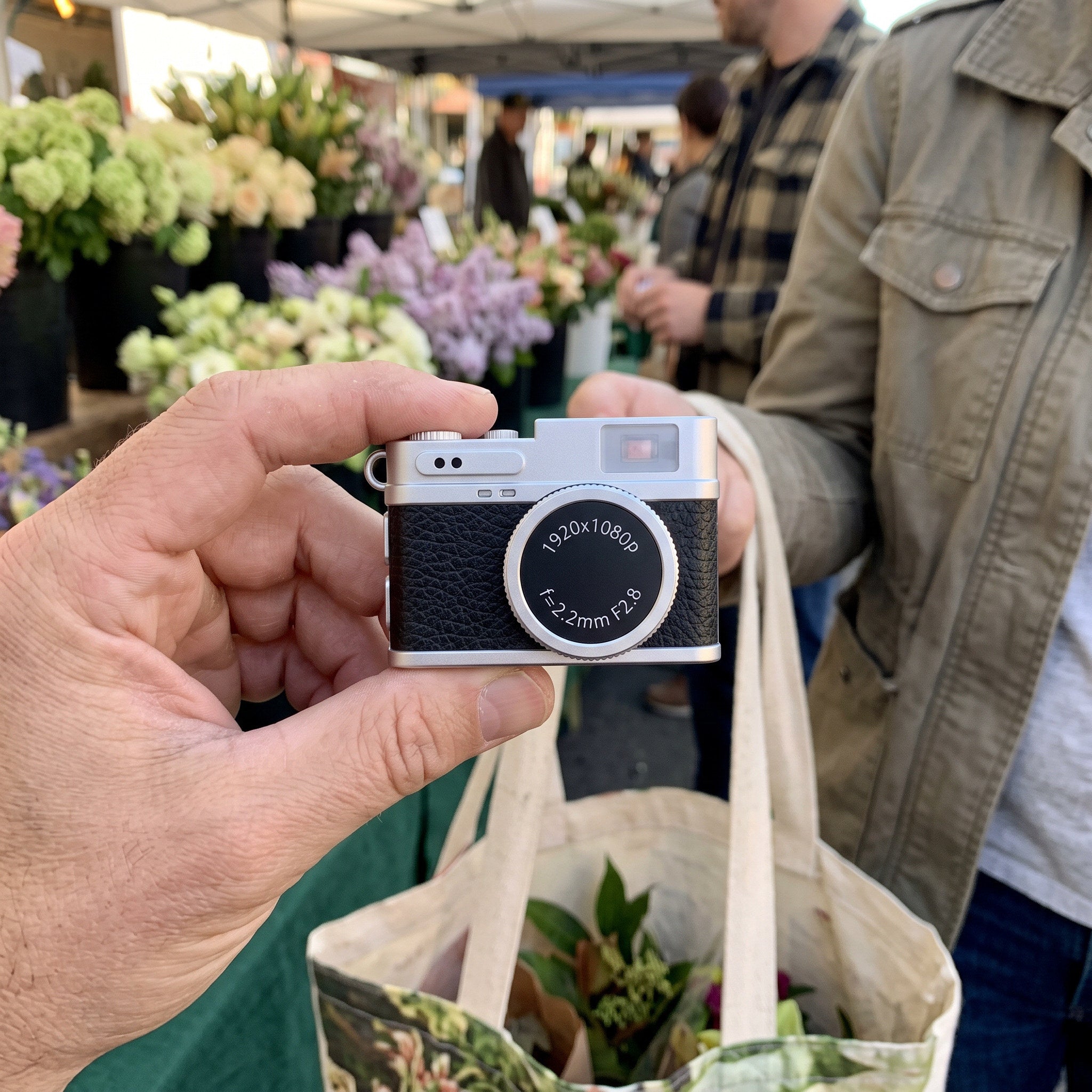 Owner holds a Little Snap camera at a weekend market